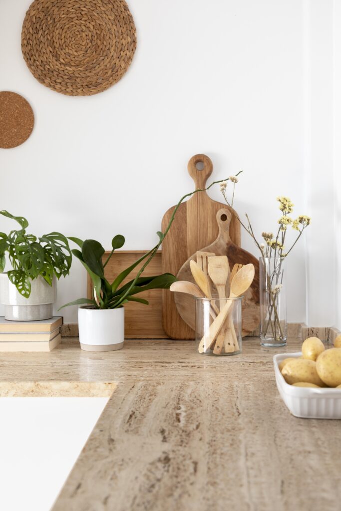 Kitchen counter with natural bamboo utensils and a simple eco friendly look with plants and vases of flowers