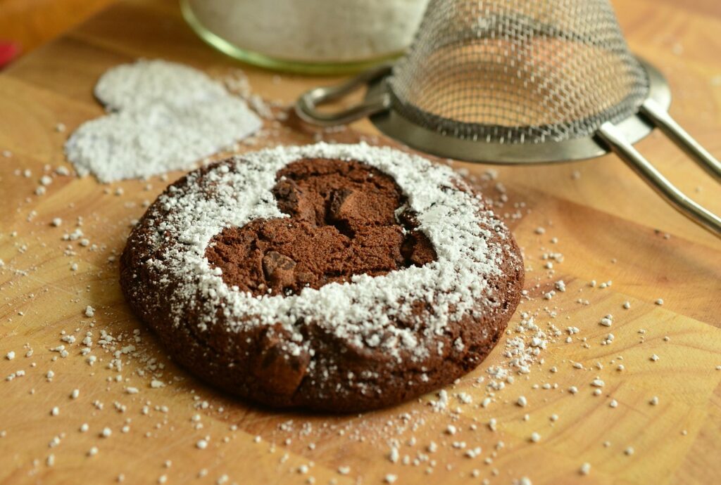 Cookie with icing sugar heart cooked in off grid kitchen showing self sufficiency
